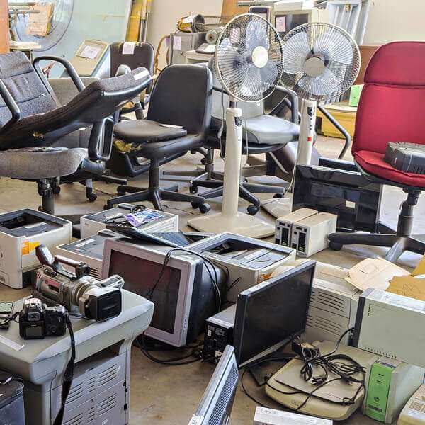 An interior space cluttered with old computers and assorted electronic equipment,